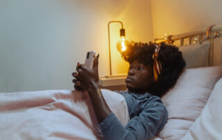 Relaxed woman using smartphone in cozy bedroom setting
